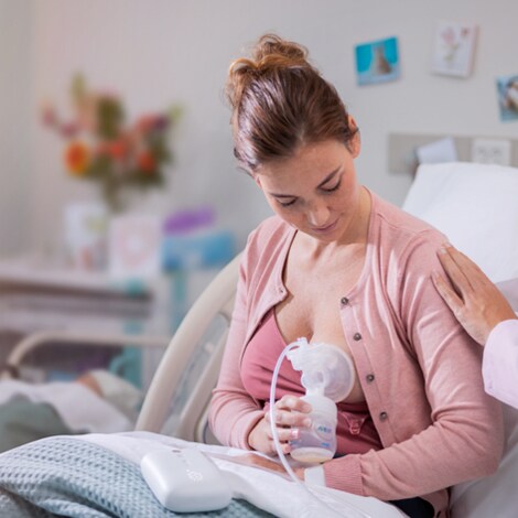 mother pumping breast milk using philips avent breast pump