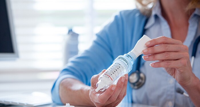 Ladies hand preparing to use Threshold PEP airway clearance device