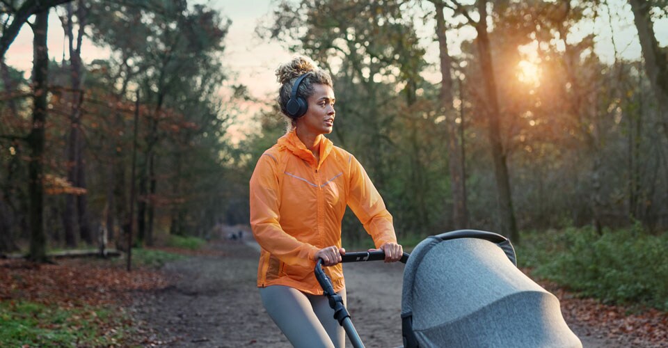 Athletin, die On-Ear-Kopfhörer während eines Spaziergangs trägt